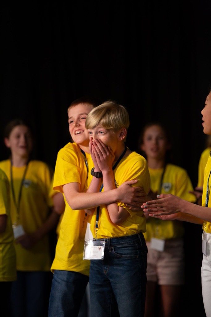 the 2024 National Memory Master champion celebrates on stage with friends