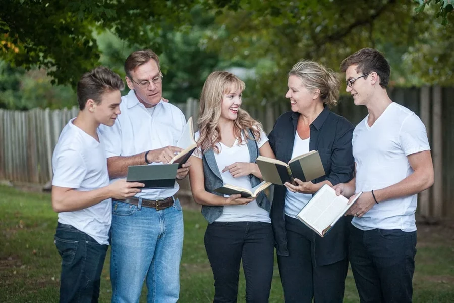 Homeschoolers read together outside.